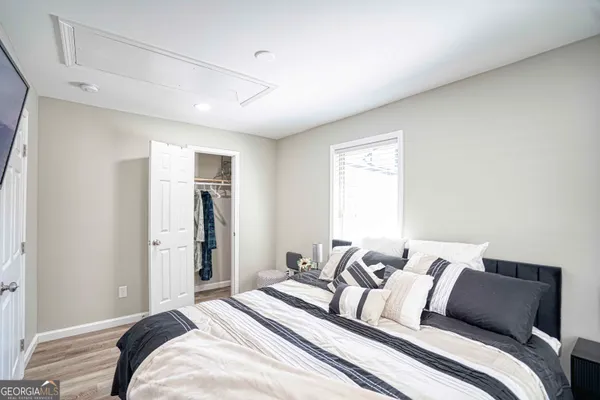 a bedroom with a bed and a painting