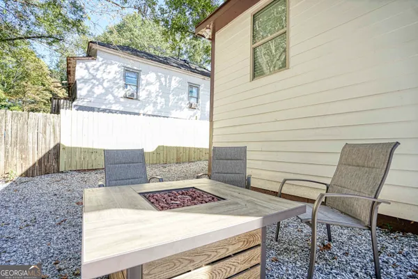 a view of a chairs and table in the patio