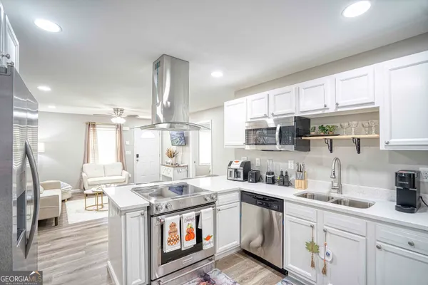 a kitchen with a stove a sink and a refrigerator