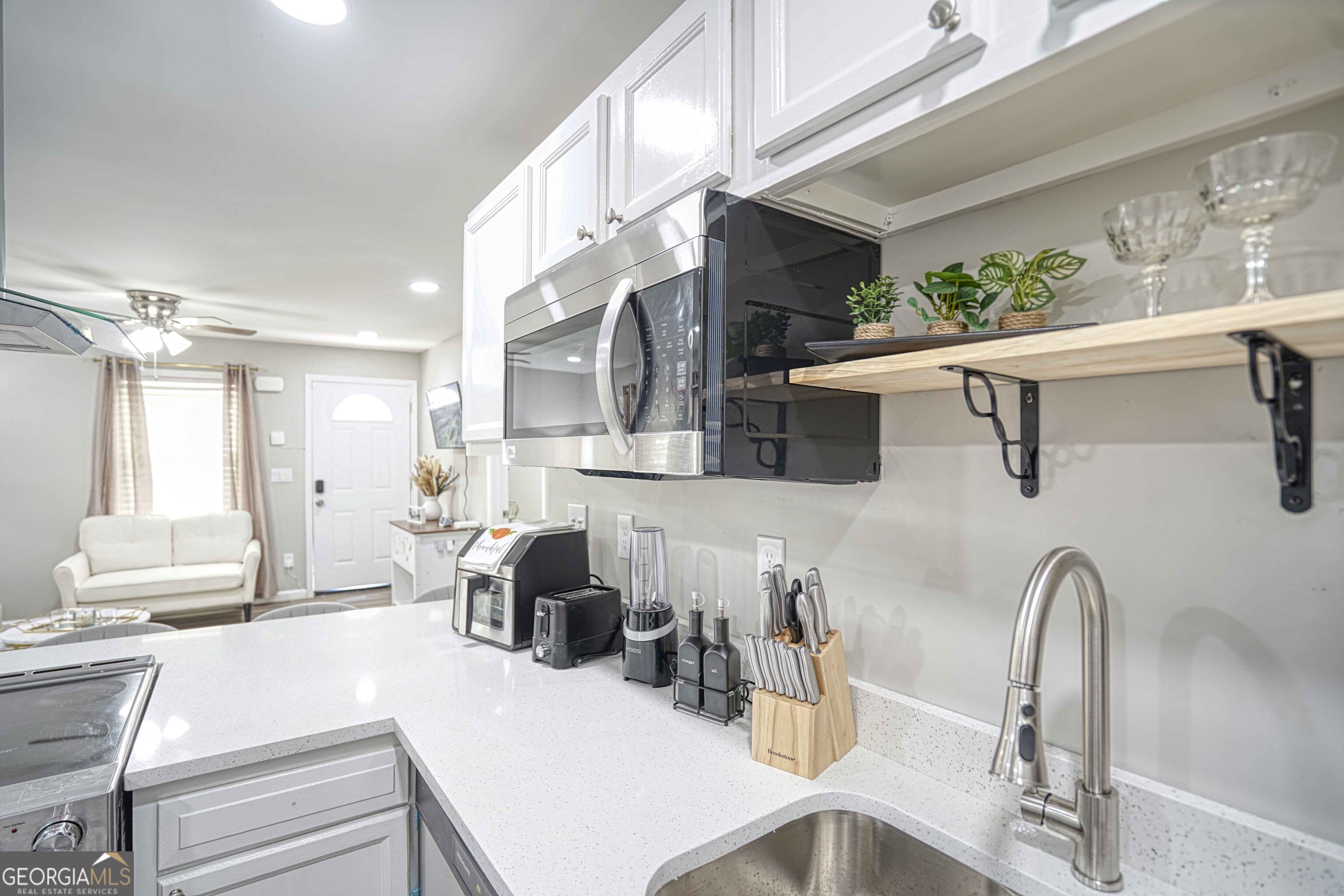 1827 Dunlap Avenue East Point, GA 30344 - Photo 9 of 32 a dining room with kitchen island stainless steel appliances furniture a large window and kitchen view