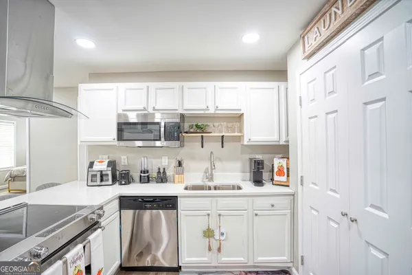 a kitchen with stainless steel appliances granite countertop a sink and cabinets