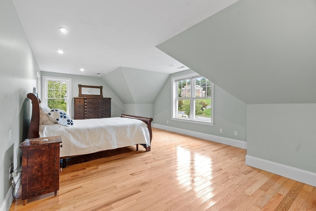 42 Fox Run Road Bolton, MA 01740 - Photo 15 of 42 a spacious bedroom with a large bed and wooden floor
