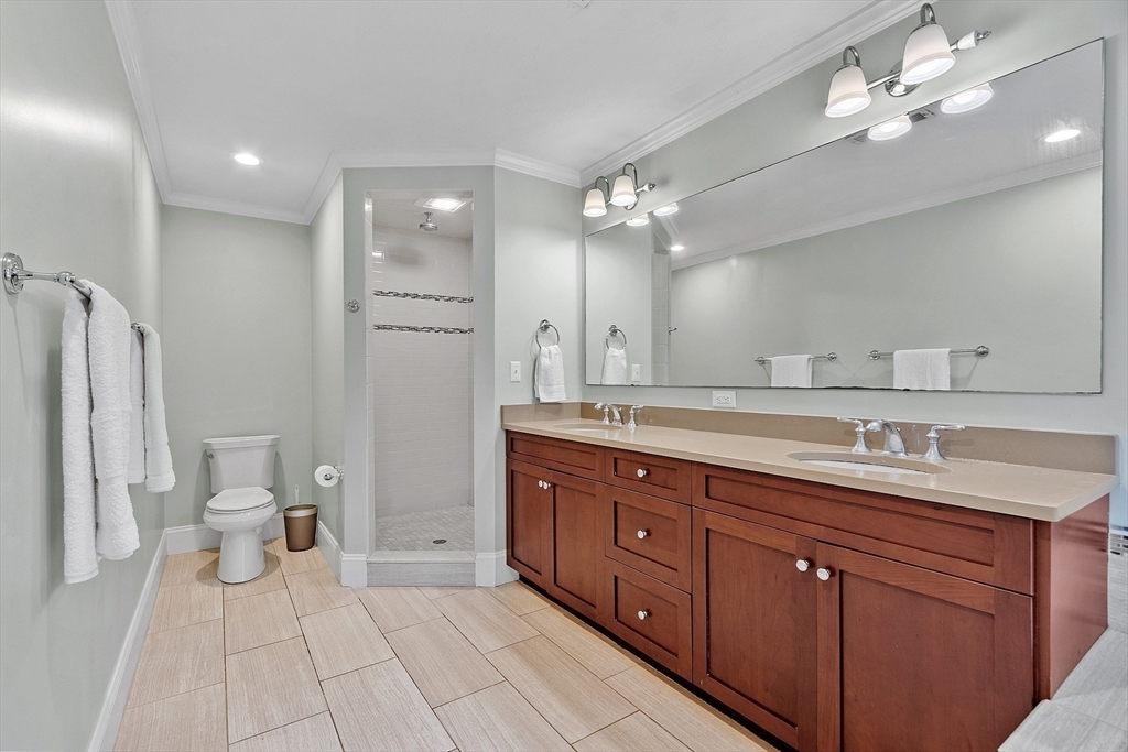 42 Fox Run Road Bolton, MA 01740 - Photo 17 of 42 a spacious bathroom with a double vanity sink a large mirror a toilet and a shower