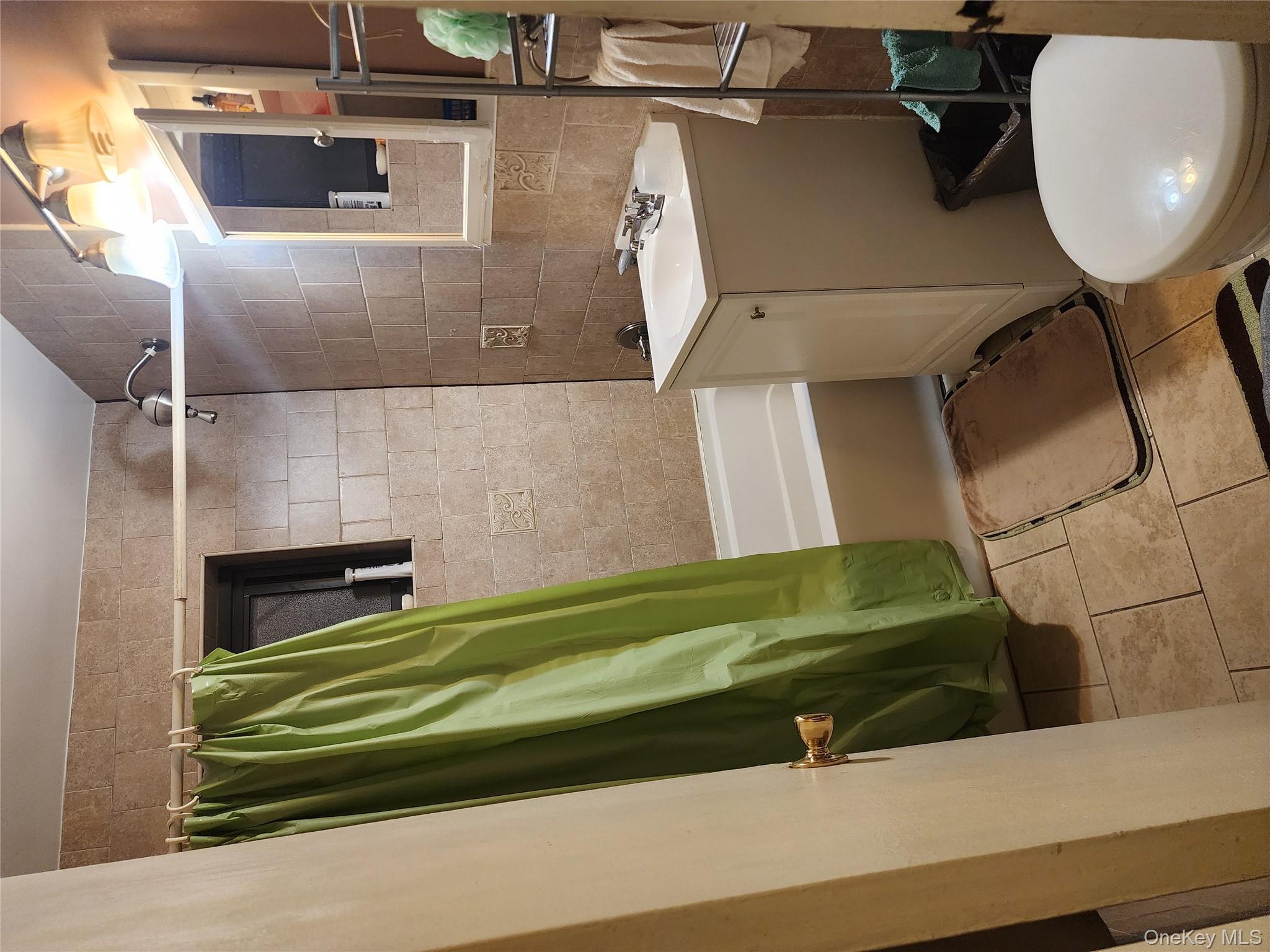 99-11 60th Avenue, Unit 3E Queens, NY 11368 - Photo 7 of 12 a bathroom with a sink a toilet and shower