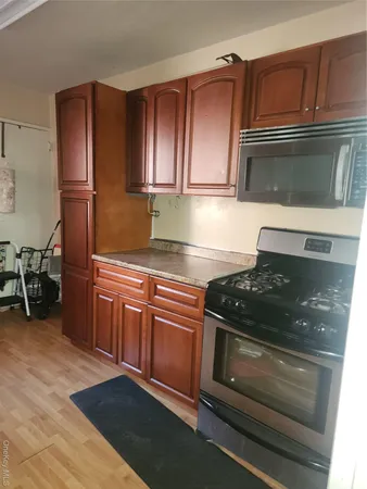 a kitchen with wooden cabinets and a stove top oven