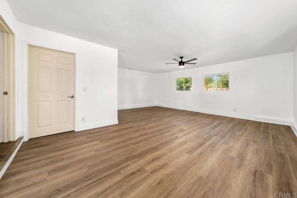 1740 Wind River Road El Cajon, CA 92019 - Photo 15 of 35 an empty room with wooden floor and windows