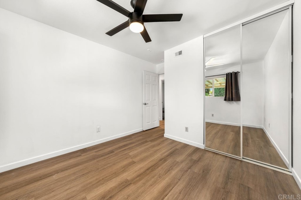 1740 Wind River Road El Cajon, CA 92019 - Photo 26 of 35 an empty room with wooden floor and windows