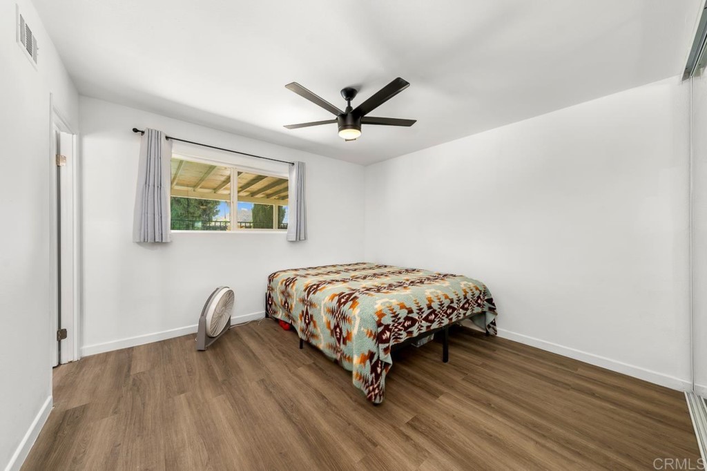 1740 Wind River Road El Cajon, CA 92019 - Photo 28 of 35 a bed room with a bed and a chandelier