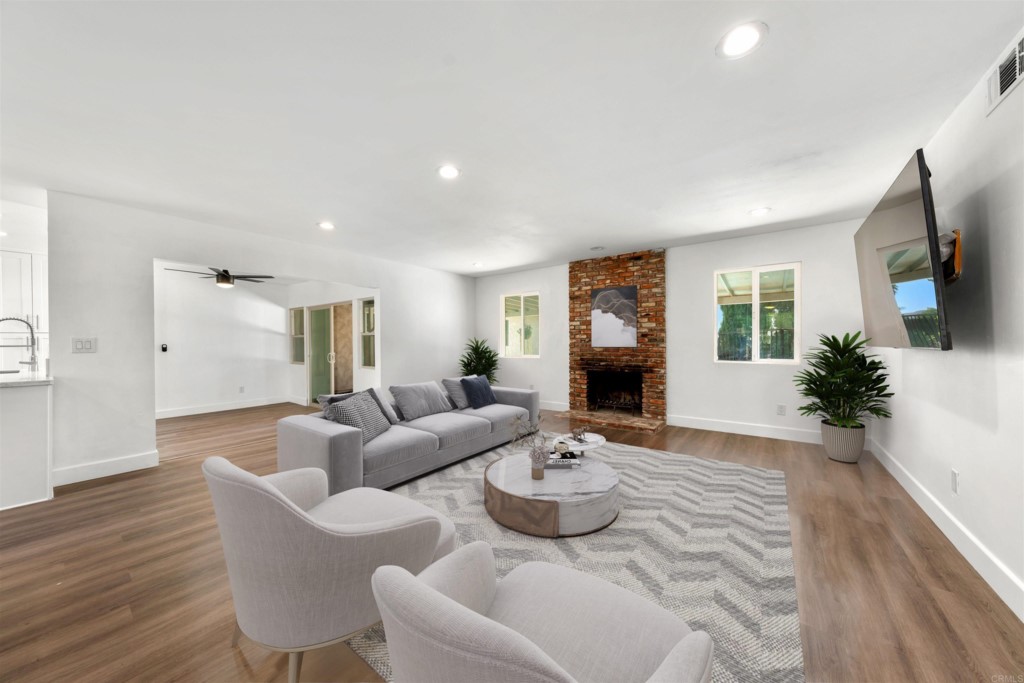 1740 Wind River Road El Cajon, CA 92019 - Photo 6 of 35 a living room with furniture potted plant and a fireplace
