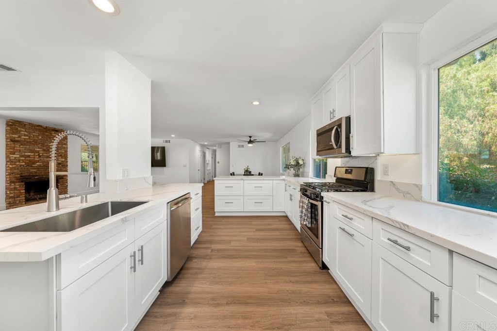 1740 Wind River Road El Cajon, CA 92019 - Photo 7 of 35 a large kitchen with stainless steel appliances lots of counter space and a sink