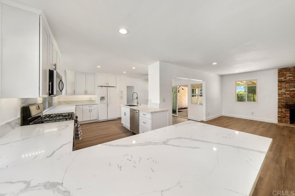 1740 Wind River Road El Cajon, CA 92019 - Photo 9 of 35 a bedroom with a bed and a view of kitchen