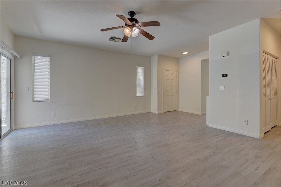 4613 Rising Cove Street Las Vegas, NV 89129 - Photo 3 of 20 This expansive living area features luminous flooring and abundant natural light, perfect for modern living.