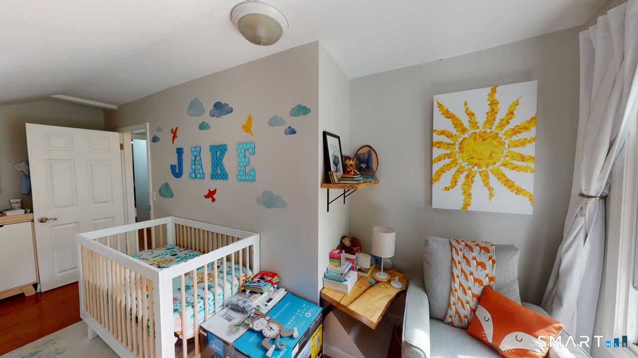 6 Eld Street New Haven, CT 06511 - Photo 12 of 43 a bedroom with baby bed toys and paintings on the wall