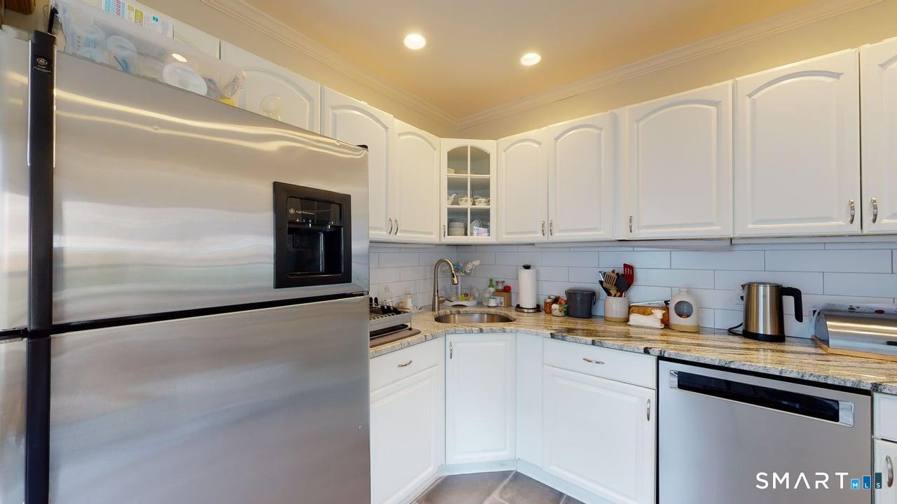 6 Eld Street New Haven, CT 06511 - Photo 13 of 43 a kitchen with stainless steel appliances cabinets a sink and a counter top space