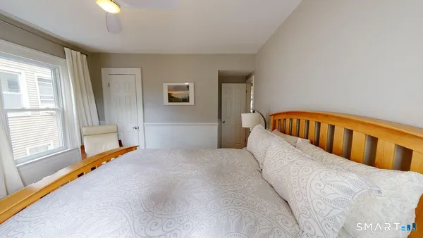 a bedroom with a bed and a window