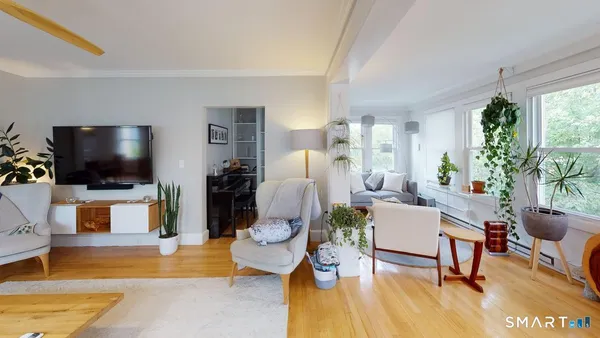 a living room with furniture and a flat screen tv