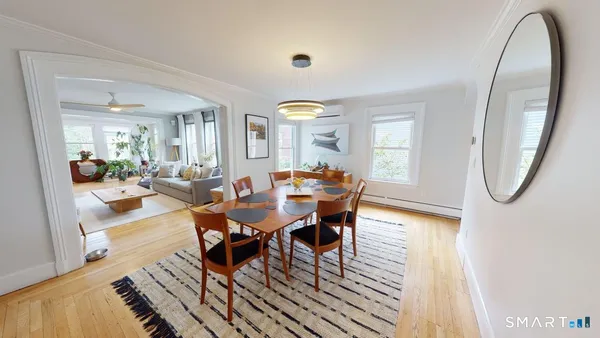 a view of a dining room with furniture and a potted plant
