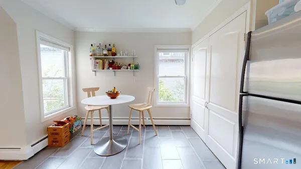 a dining room with furniture and a window