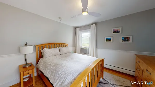 a bedroom with a bed and a lamp on table