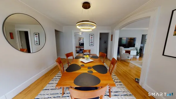 a dining room with furniture and a mirror