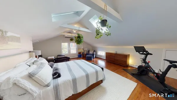 a bedroom with bed and a mirror