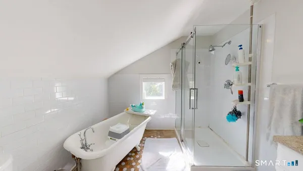a bathroom with a bathtub and shower