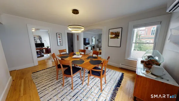 a view of a dining room with furniture and wooden floor