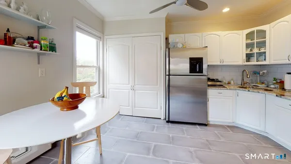 a kitchen with stainless steel appliances a refrigerator sink and cabinets
