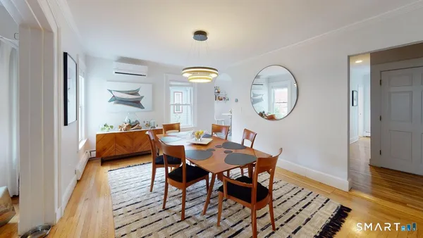 a view of a dining room with furniture and wooden floor