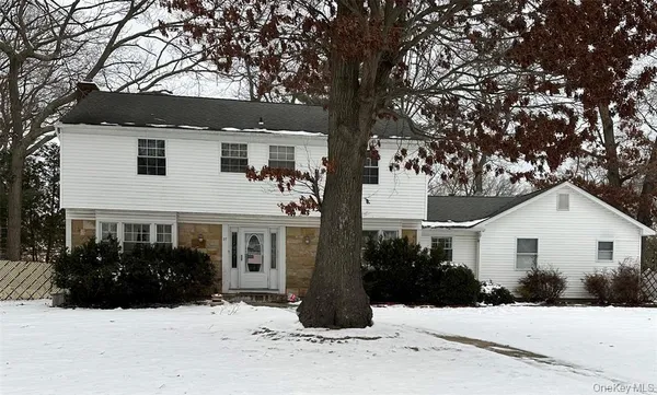 a view of house with a yard covered in snow
