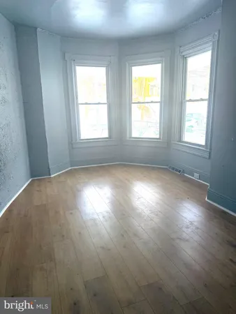 a view of room with window and hardwood floor