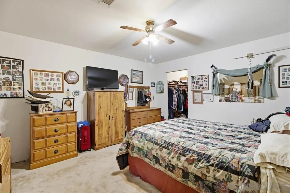 1478 Peutz Valley Road Alpine, CA 91901 - Photo 17 of 63 a bedroom with a bed dresser and flat screen tv