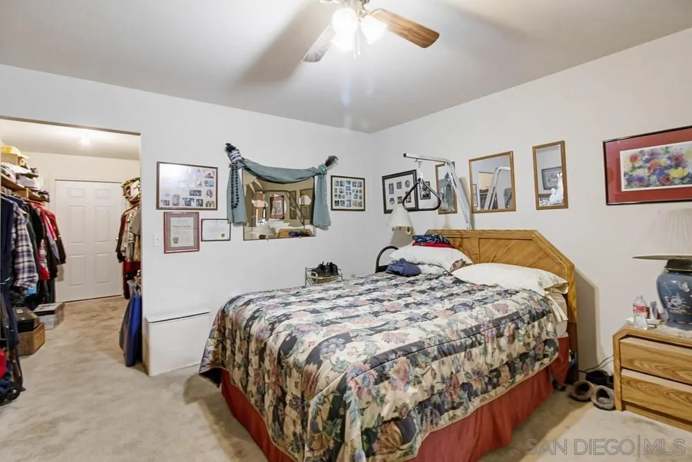 1478 Peutz Valley Road Alpine, CA 91901 - Photo 18 of 63 a bedroom with a bed and ceiling fan