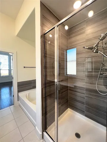 a bathroom with a double vanity sink a mirror and a shower