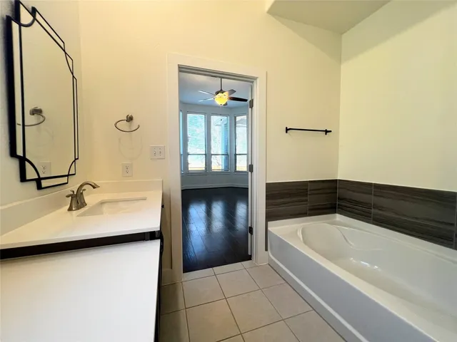 a bathroom with a tub and shower