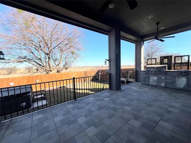 a kitchen with granite countertop a stove and cabinets