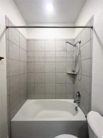 a bathroom with a shower and a bathtub
