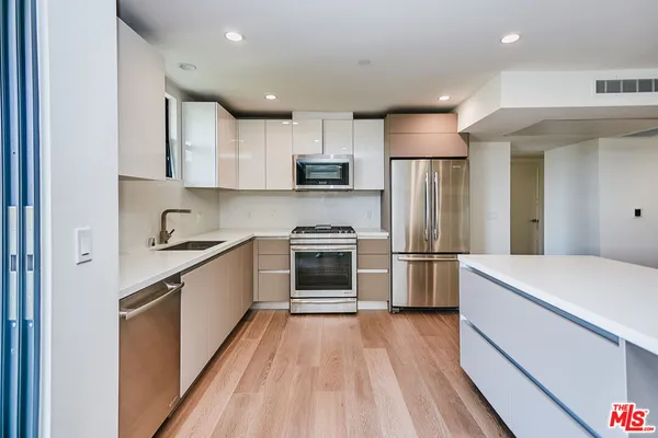 a kitchen with a white stove top oven and refrigerator