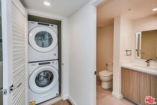 a utility room with sink dryer and washer