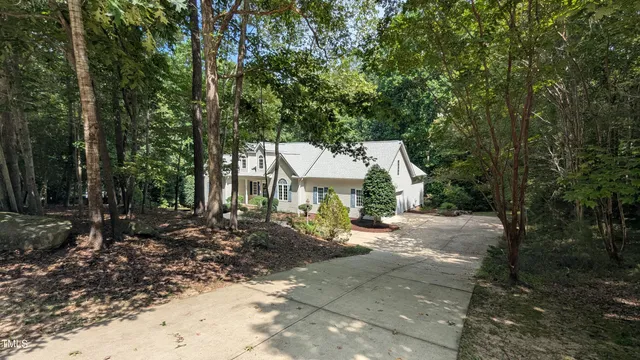 a view of a house with a tree in the background