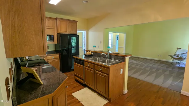a kitchen with a sink appliances and cabinets