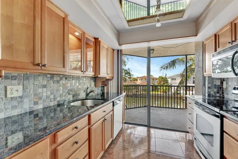 a spacious bathroom with a double vanity sink a large mirror and a bathtub