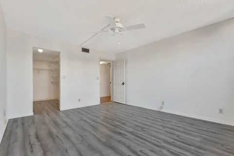 a living room with furniture and large windows