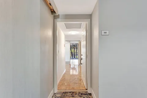 a view of an entryway with a floor to ceiling window and an outdoor view