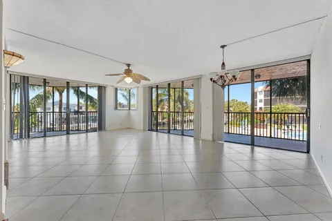 a kitchen with stainless steel appliances granite countertop a sink a stove cabinets and a dining table