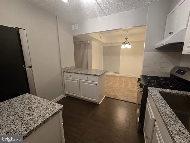 a kitchen with a sink and a stove top oven