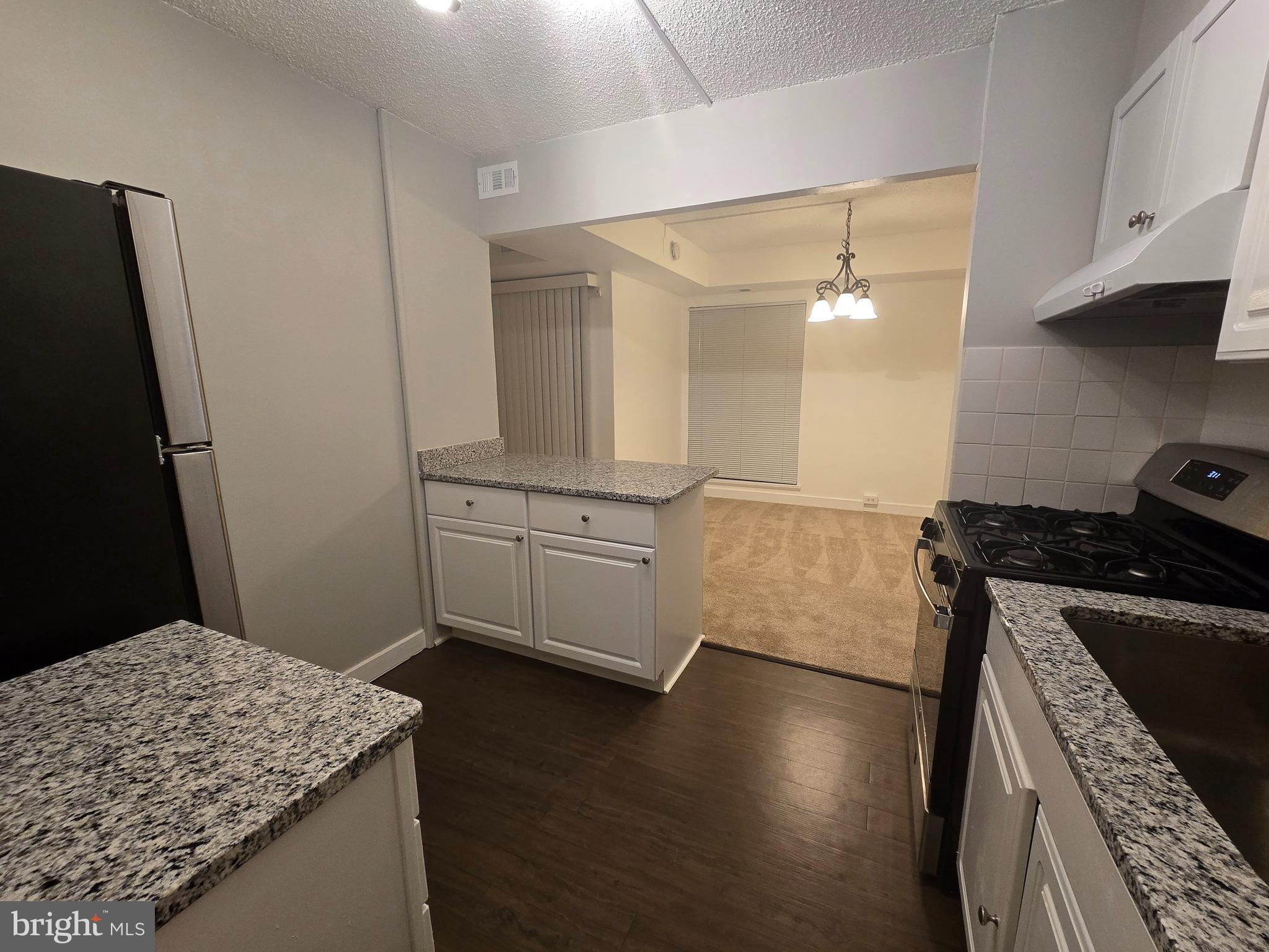 5901 Tamar Drive, Unit 10 S10 Columbia, MD 21045 - Photo 2 of 27 a kitchen with a sink and a stove top oven