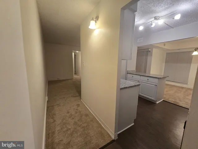 en empty room with wooden floor and entrance