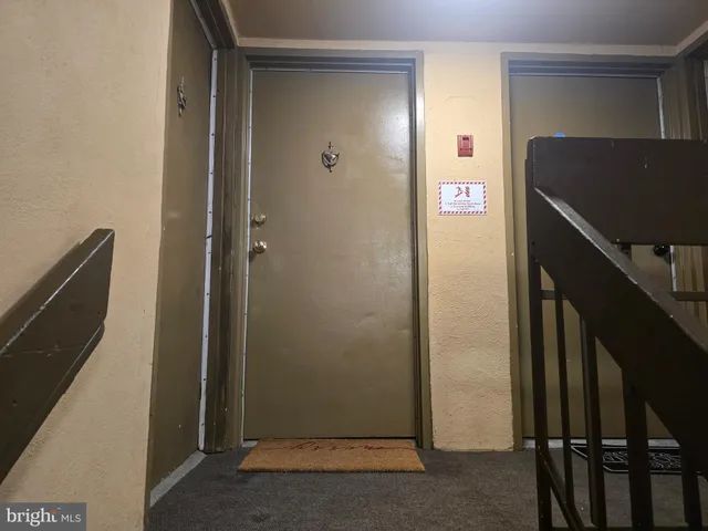 a view of a hallway with workspace and closet area