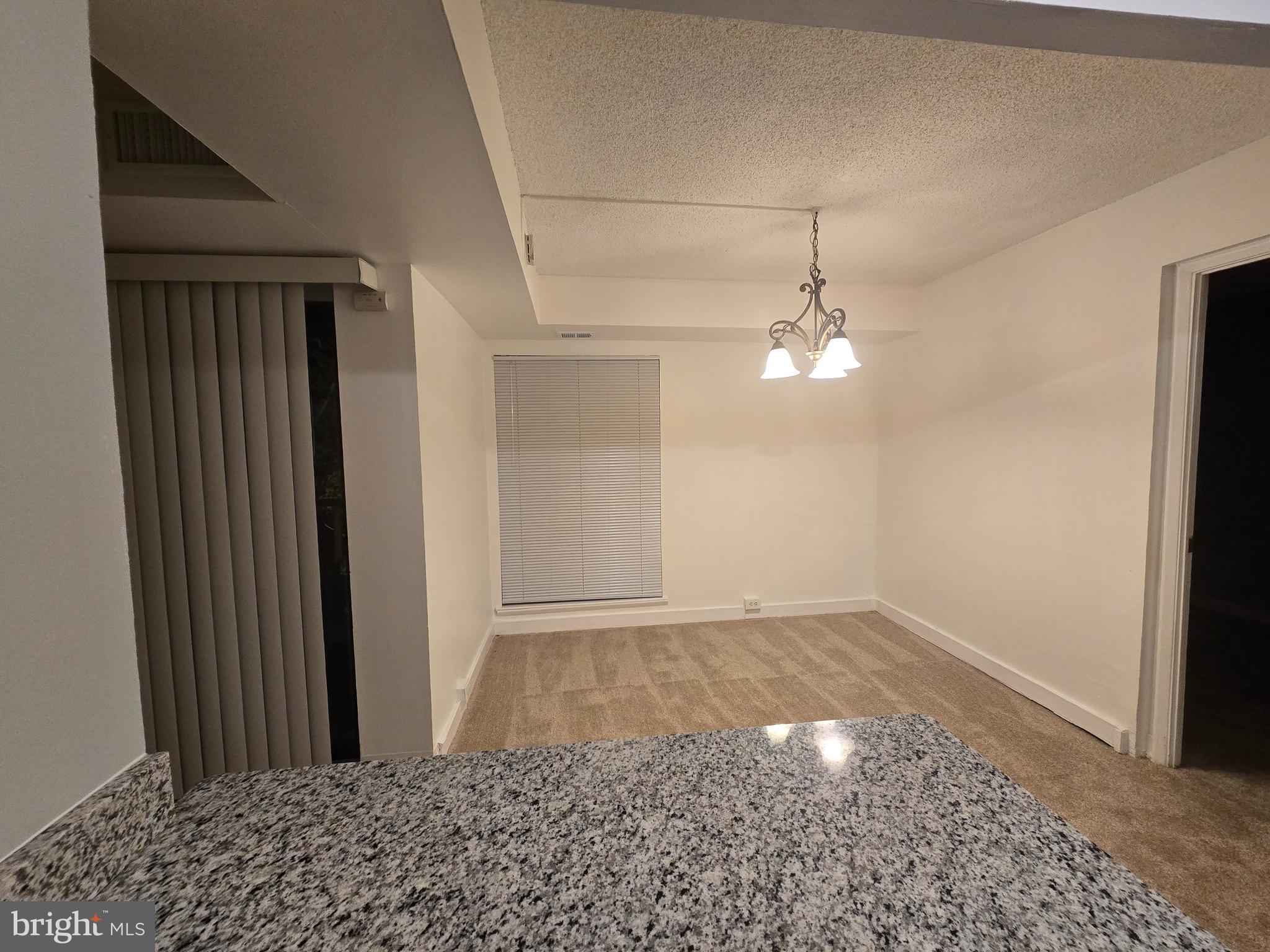 5901 Tamar Drive, Unit 10 S10 Columbia, MD 21045 - Photo 7 of 27 a view of a hallway with a chandelier fan
